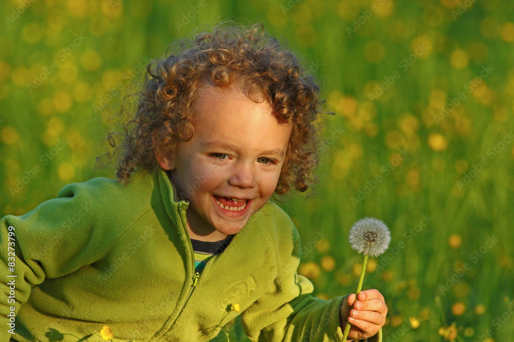 Little boy happily running through a field of yellow flowers Little boy happily running through a field of yellow flowers