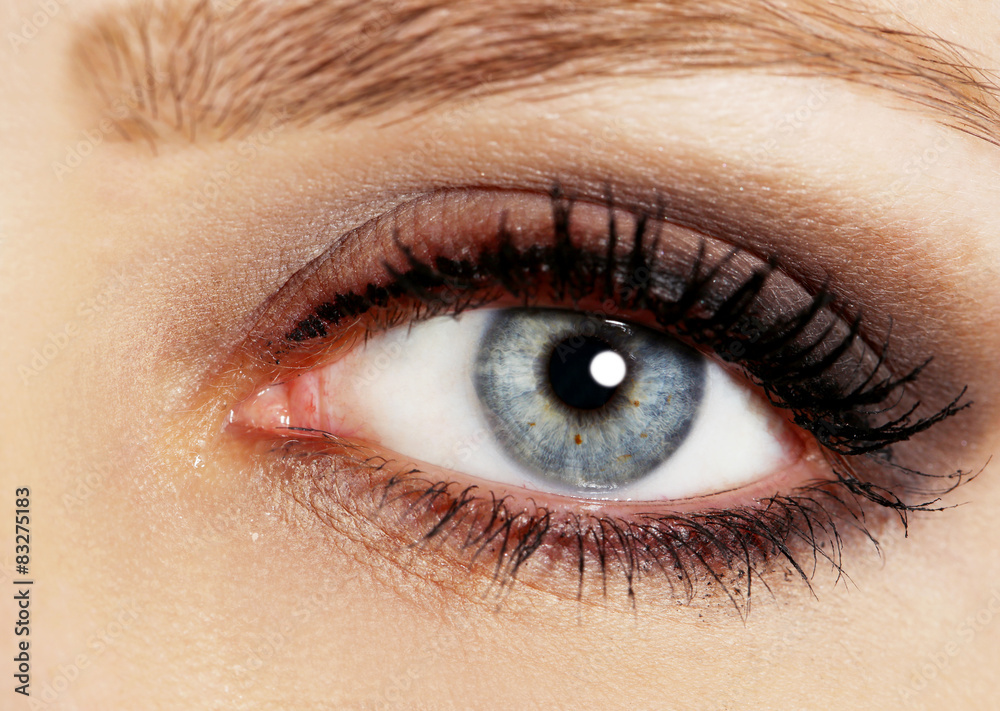 Eye of young woman with tear drop close up Eye of young woman with tear drop close up