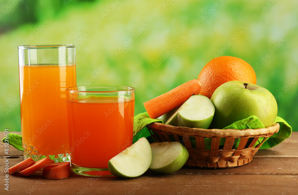 Glass of healthy fresh juice of apples and carrots on wooden background Glass of healthy fresh juice of apples and carrots on wooden background