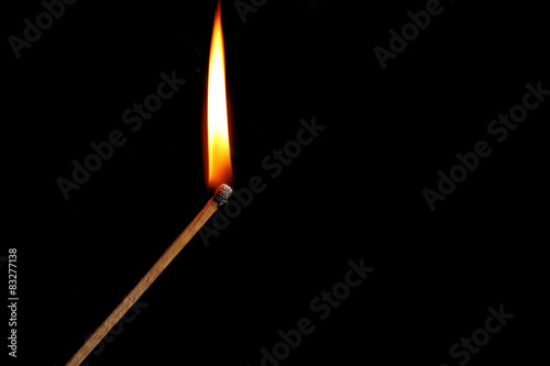 Burning match with smoke on dark background