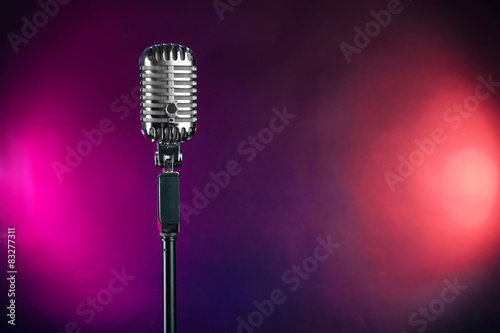 Retro microphone on colorful blurred background