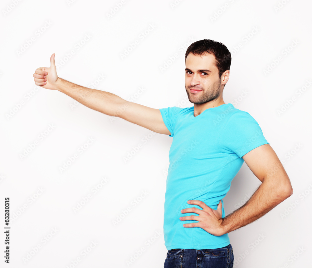 happy young man showing thumbs up