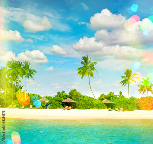Tropical island sand beach with palm trees. Sunny blue sky with