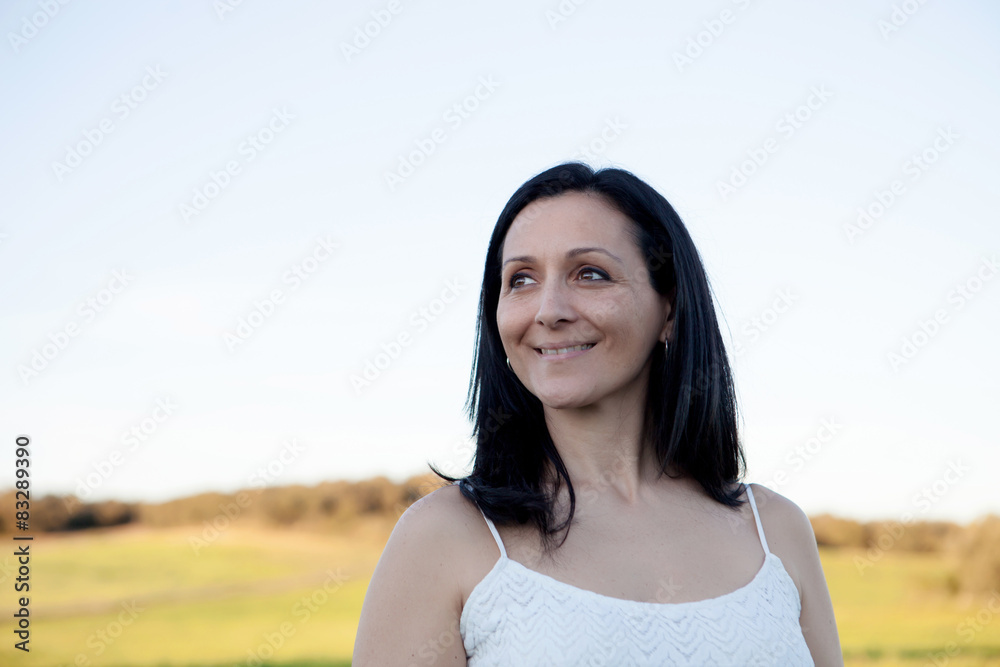 Woman looking at side relaxing on a meadow