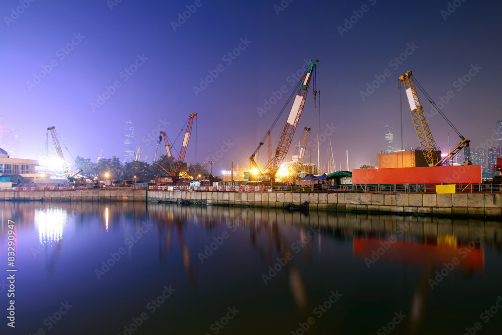 construction site and cranes near pond