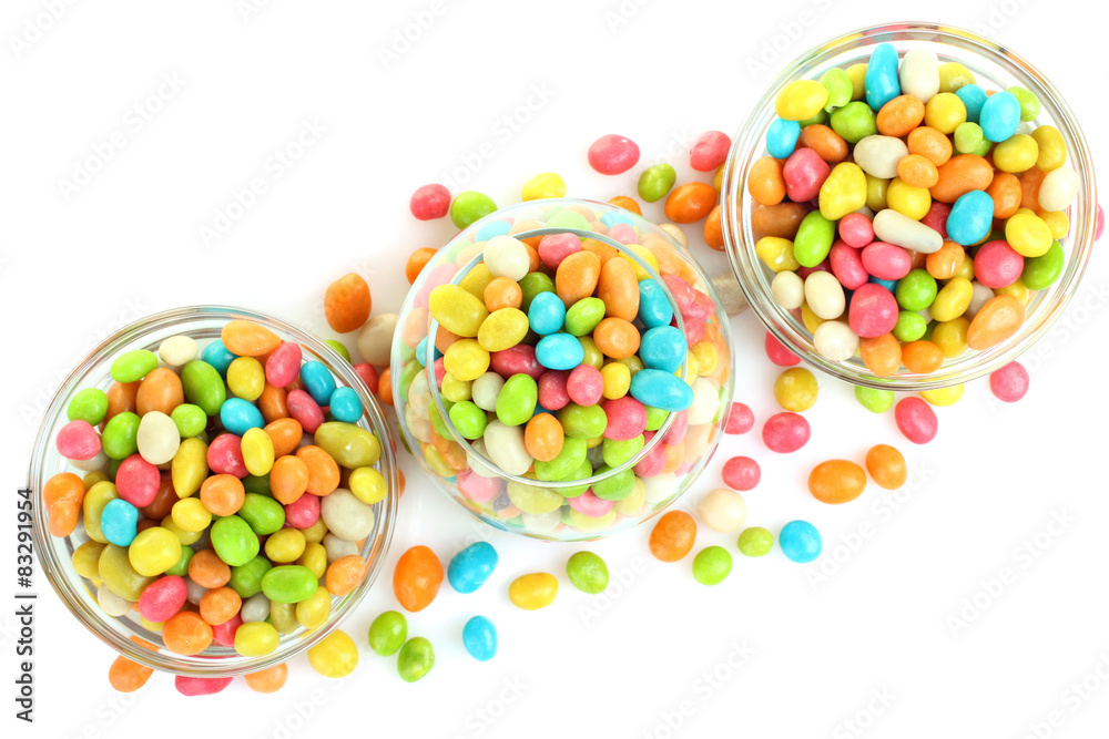 Colorful candies in glass bowl isolated on white