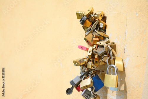 padlocks on a yellow wall