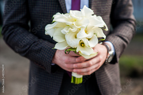 bouquet in hands of the groom