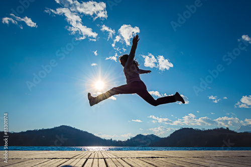 Girl jumping in the sun photo