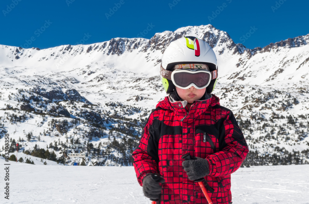 Boy skiing at mountains in helmet and mask