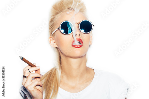 Sexy blonde woman in sunglasses smoking cigar
