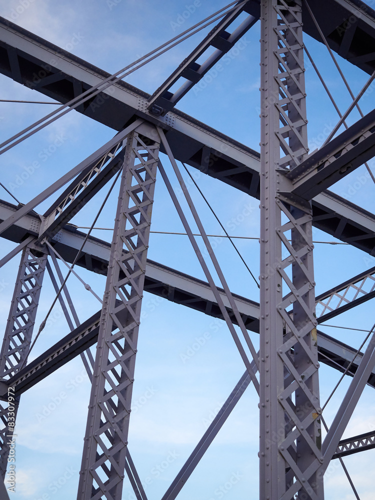 Detail of painted riveted bridge against blue sky. Detail of painted riveted bridge against blue sky.