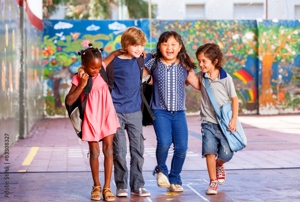 Schoolchildren embracing happy. Multi cultural racial classroom - obrazy, fototapety, plakaty 
