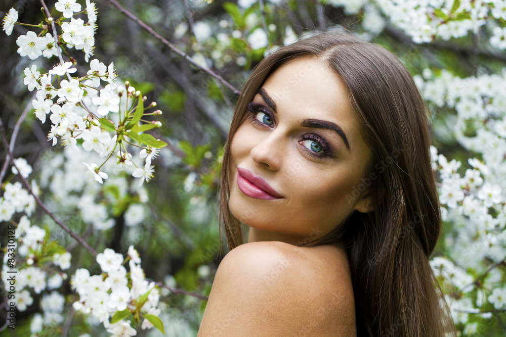 Fototapeta premium Close up portrait of a beautiful young girl on the background of