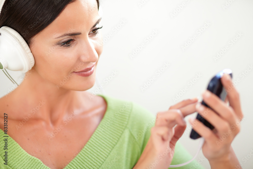 Calm woman using a portable music player Calm woman using a portable music player