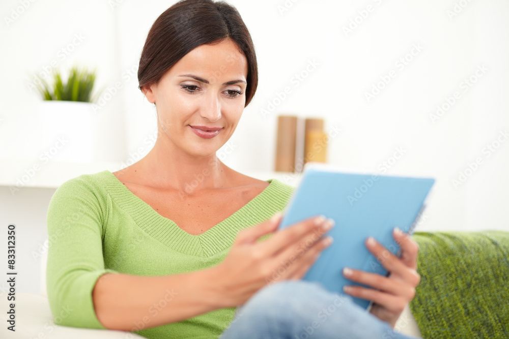 Carefree young woman looking at a tablet Carefree young woman looking at a tablet