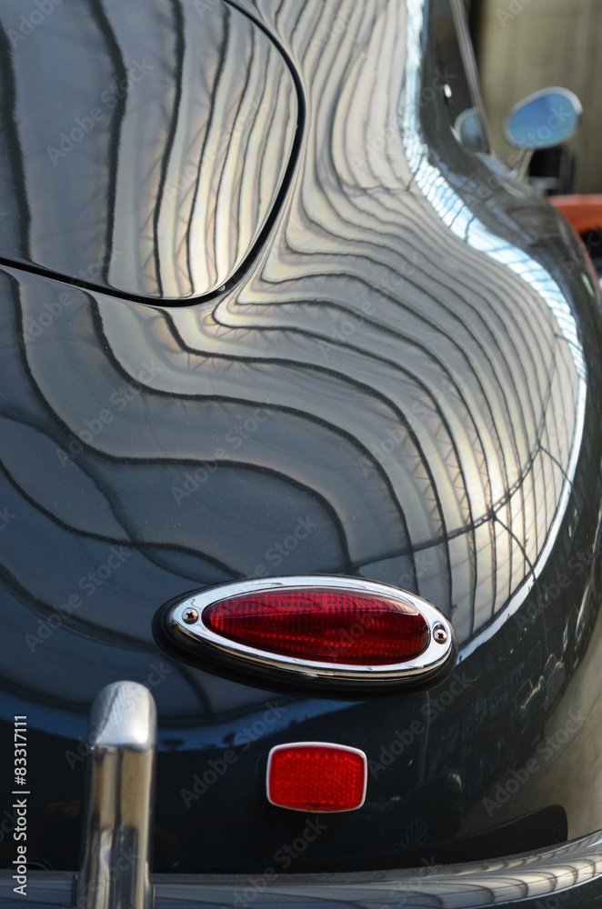 Interesting form of old black car with original rear lamps stop