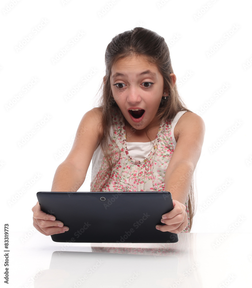 Surprised pre-teen girl with a tablet computer. Surprised pre-teen girl with a tablet computer.