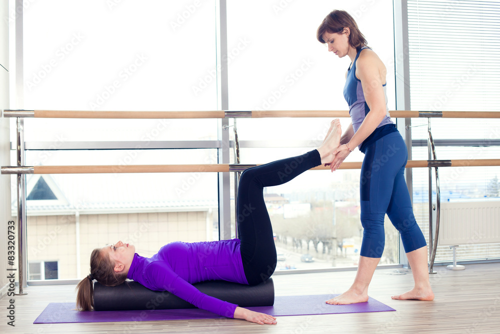 Aerobics Pilates personal trainer helping women group in a gym Aerobics Pilates personal trainer helping women group in a gym