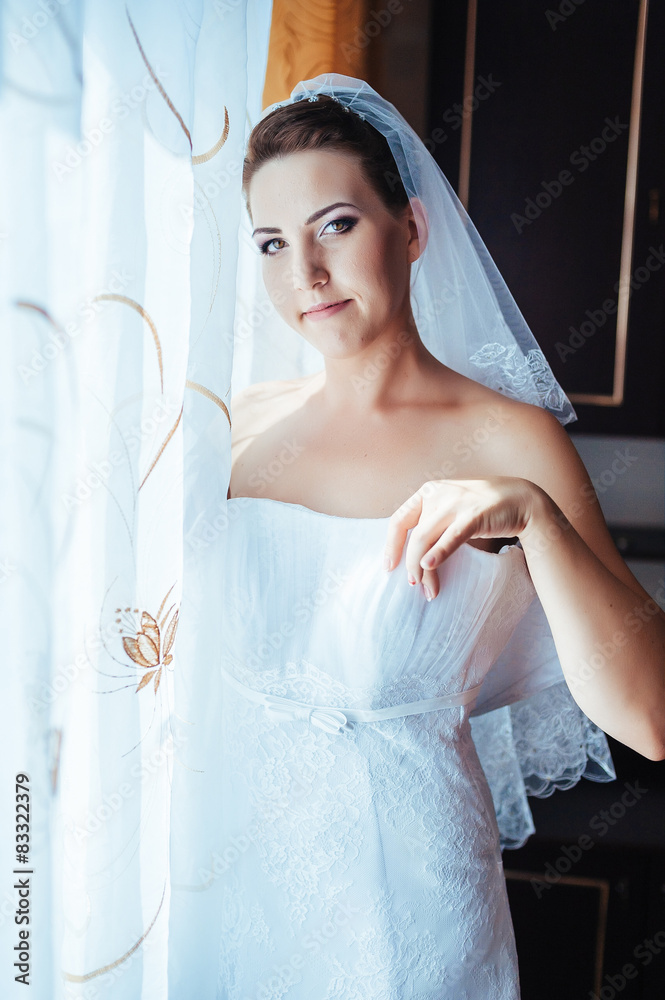 Fototapeta premium Bride getting ready. beautiful bride in white wedding dress with