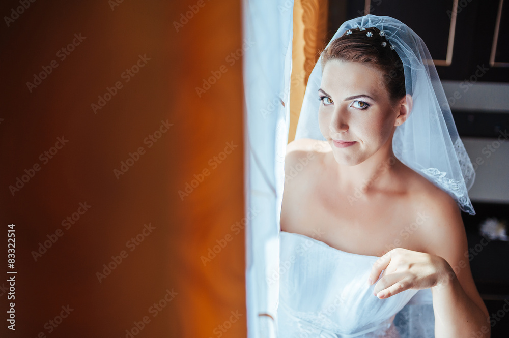 Fototapeta premium Bride getting ready. beautiful bride in white wedding dress with