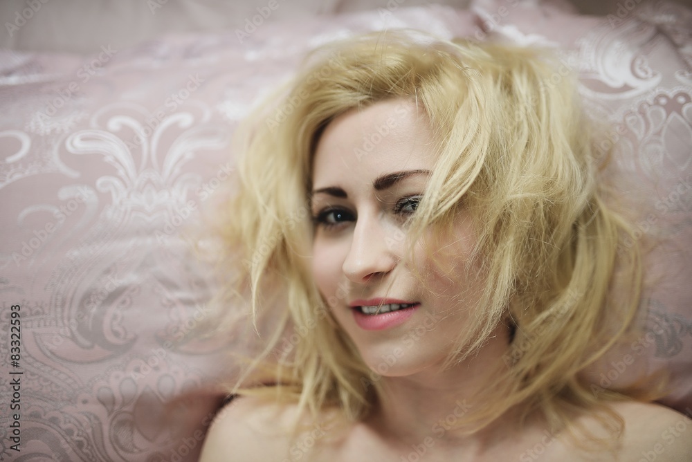 Young beautiful girl wakes up in the morning in a bed Young beautiful girl wakes up in the morning in a bed