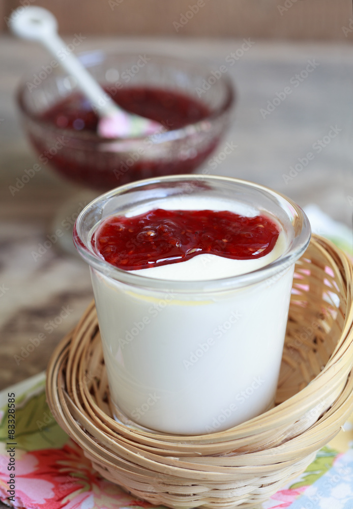 Small jar homemade yogurt with raspberry jam in a wicker baskets Small jar homemade yogurt with raspberry jam in a wicker baskets
