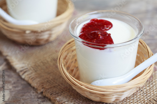 Two small jars homemade yogurt with raspberry jam 