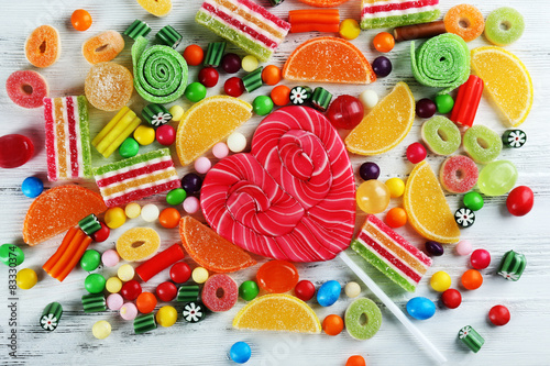Colorful candies on wooden background © Africa Studio
