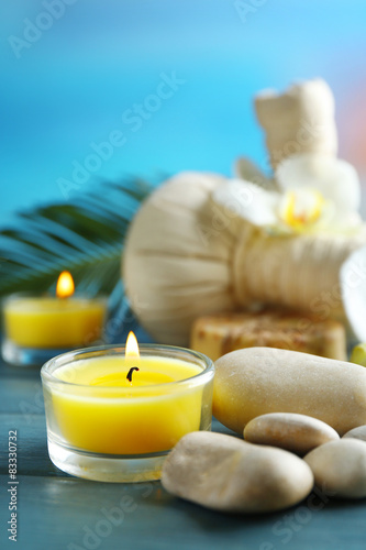 Still life with beautiful blooming orchid flower  spa treatment on wooden table  on bright background