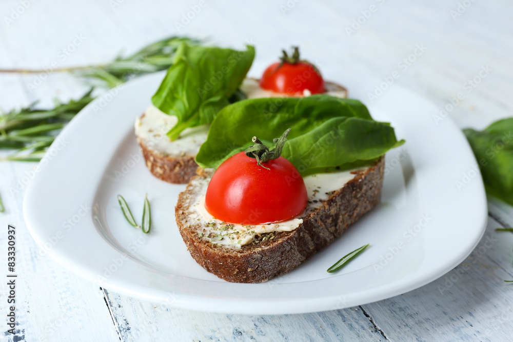 Delicious sandwiches with tomatoes and greens on plate table close up Delicious sandwiches with tomatoes and greens on plate table close up