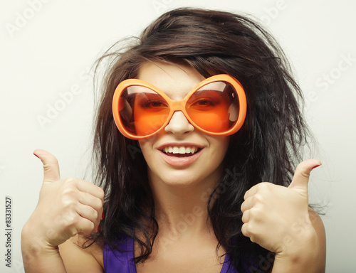 young woman showing thumbs up gesture 