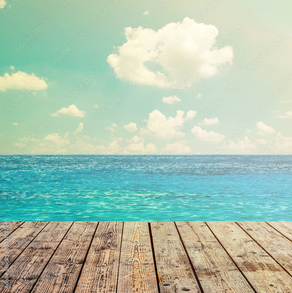 Fototapeta premium Blue ocean and sky above wooden floor