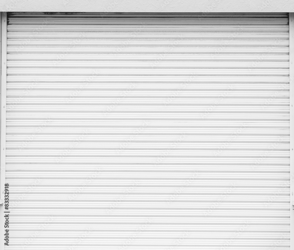Fototapeta premium White metal roller door shutter background and texture .