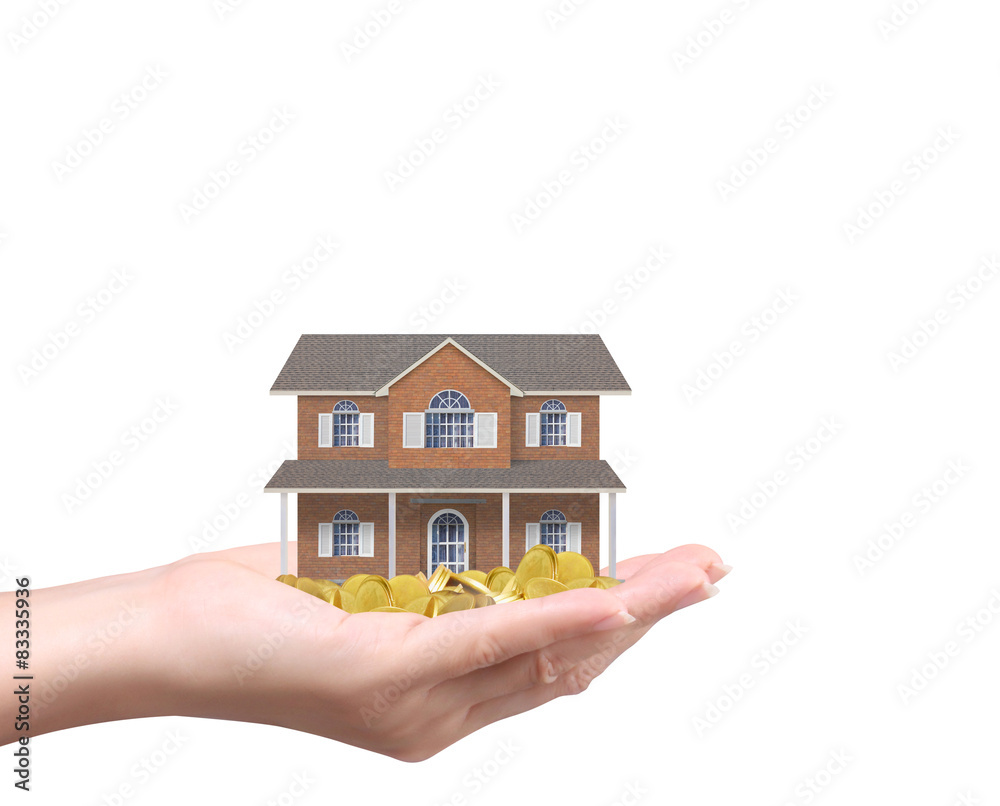 Businessman holding home model and coins Businessman holding home model and coins