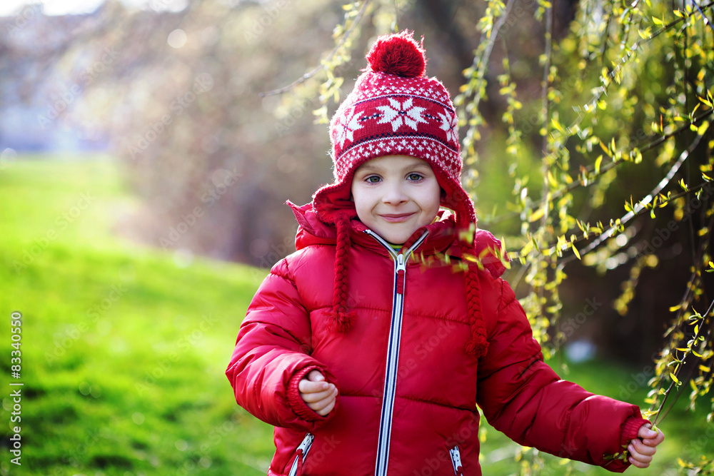 Funny little boy, enjoying sunny spring day at the park