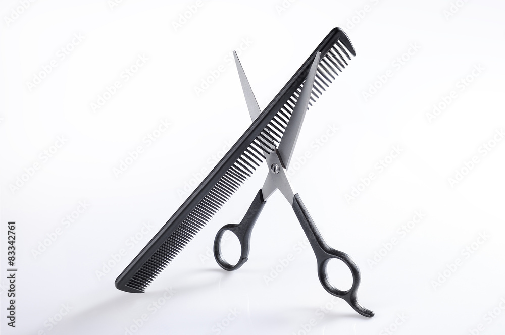 Scissors and comb standing on a table isolated Scissors and comb standing on a table isolated