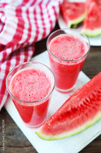 Watermelon smoothies on brown wooden background