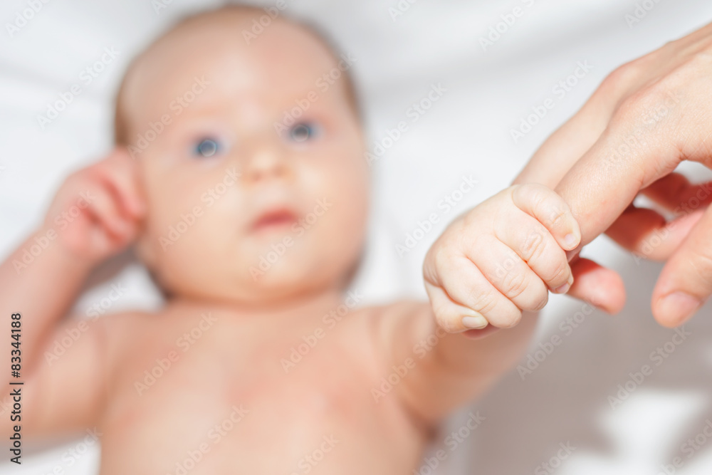 newborn baby holding her mother's finger newborn baby holding her mother's finger