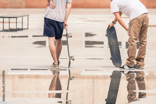 handsome guys with skateboard at freestyle park outdoors