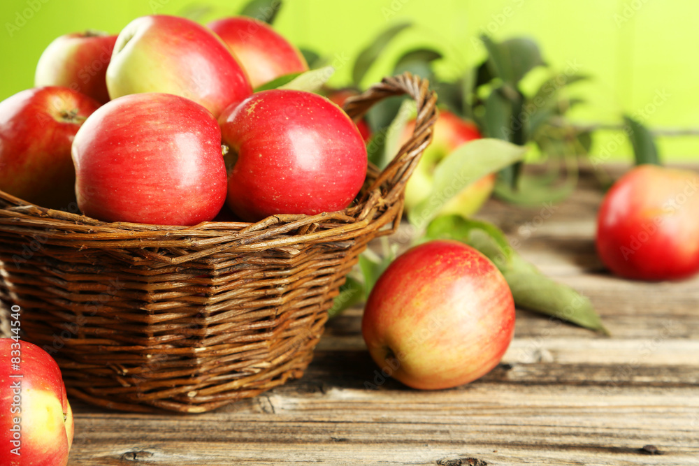 Apples in basket on brown wooden background Apples in basket on brown wooden background