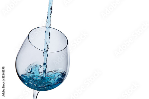 Water poured into a glass on a white background
