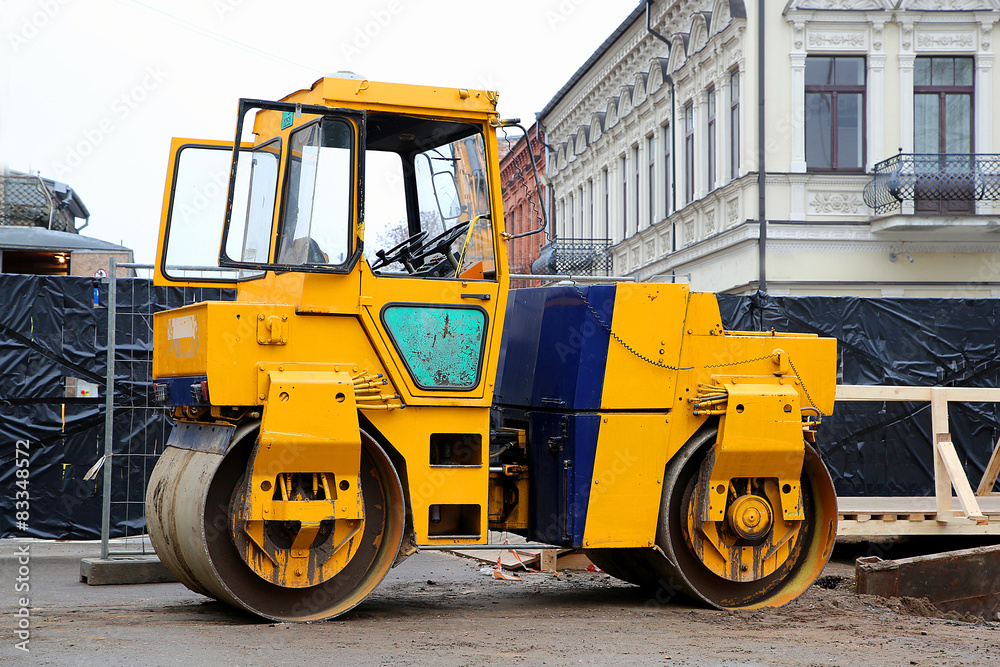 Heavy yellow roller compactor asphalting