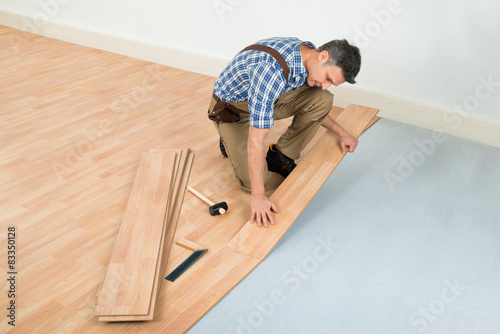 Man Installing New Laminated Wooden Floor