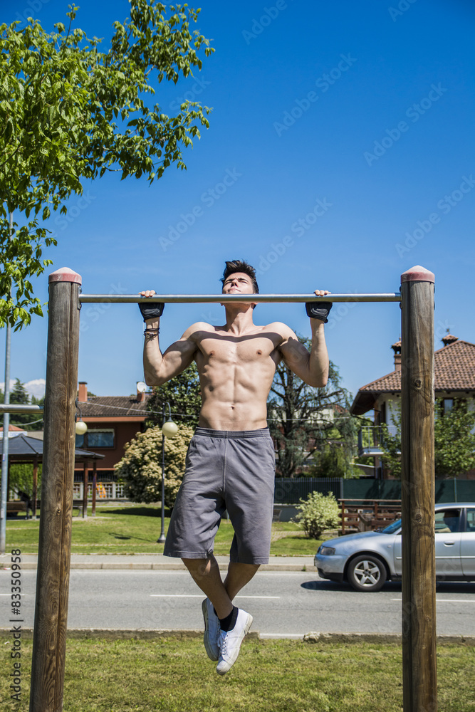 Fototapeta premium Attractive shirtless young man exercising outdoor in city park