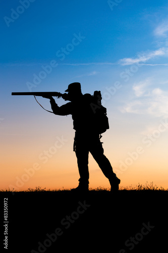 Hunter with shotgun in sunset © zorandim75