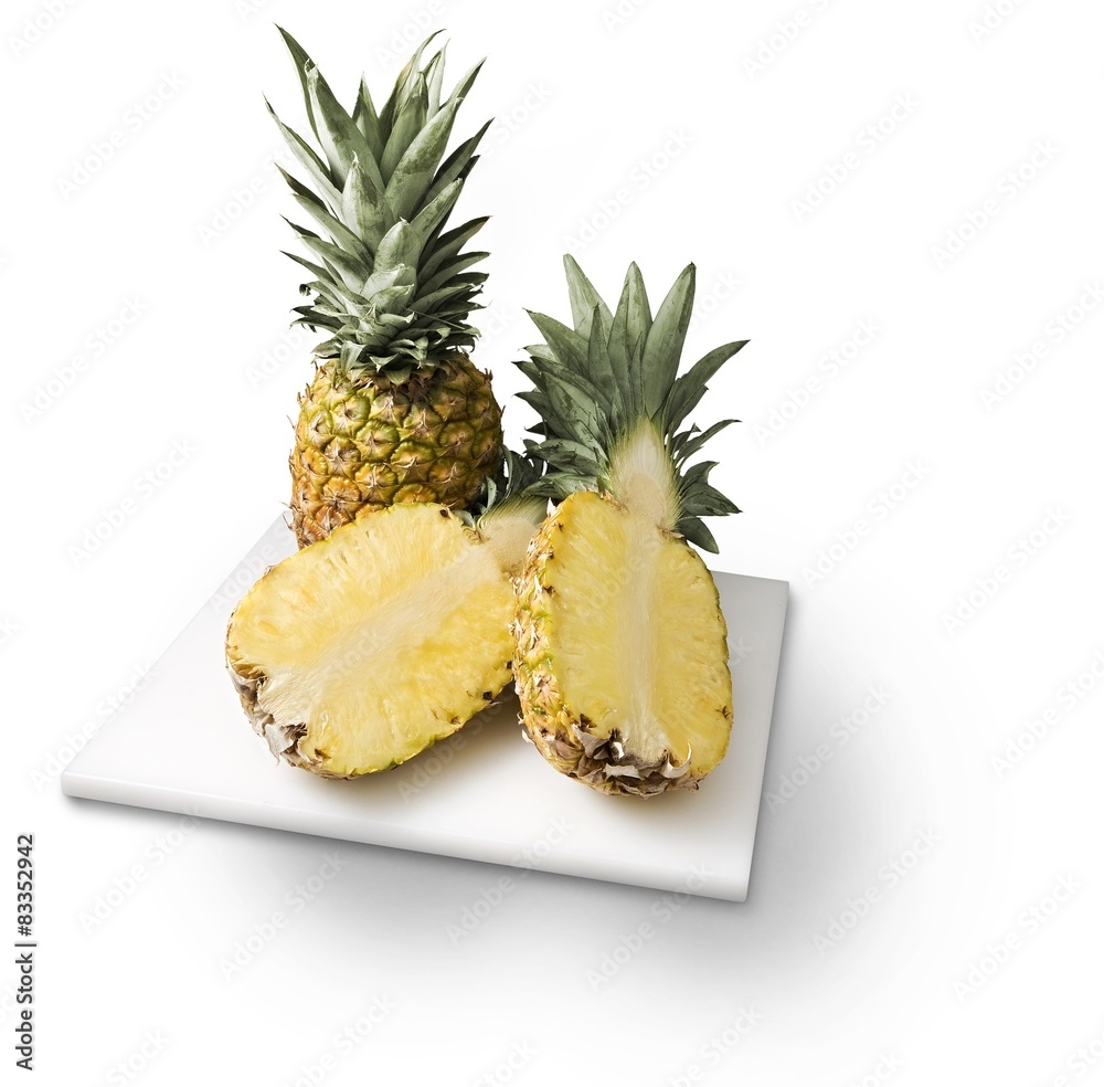 Pineapples on cutting board isolated on white Pineapples on cutting board isolated on white