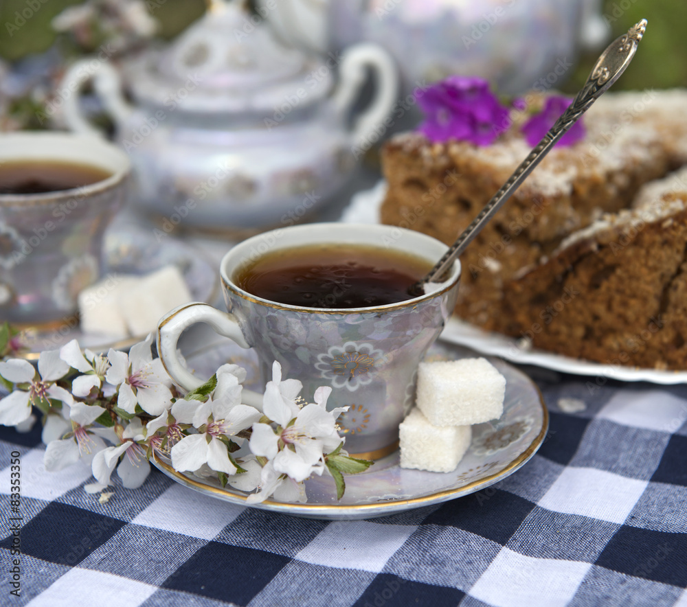 Still life with cup of tea, cake and cherry tree flowers Still life with cup of tea, cake and cherry tree flowers