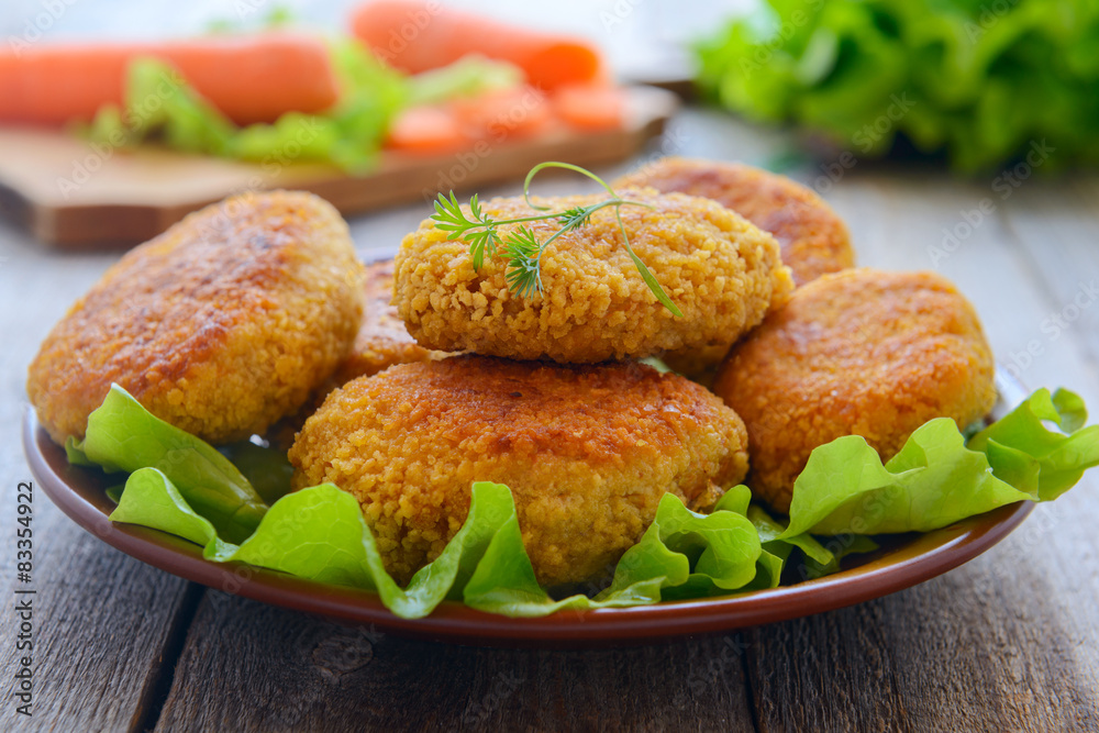Dietetic carrots cutlets on wooden table Dietetic carrots cutlets on wooden table