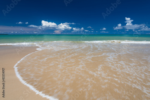 Fototapeta Naklejka Na Ścianę i Meble -  sea waves lash line impact on the sand beach under blue sky